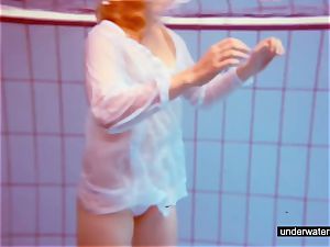 super-cute ginger-haired plays bare underwater
